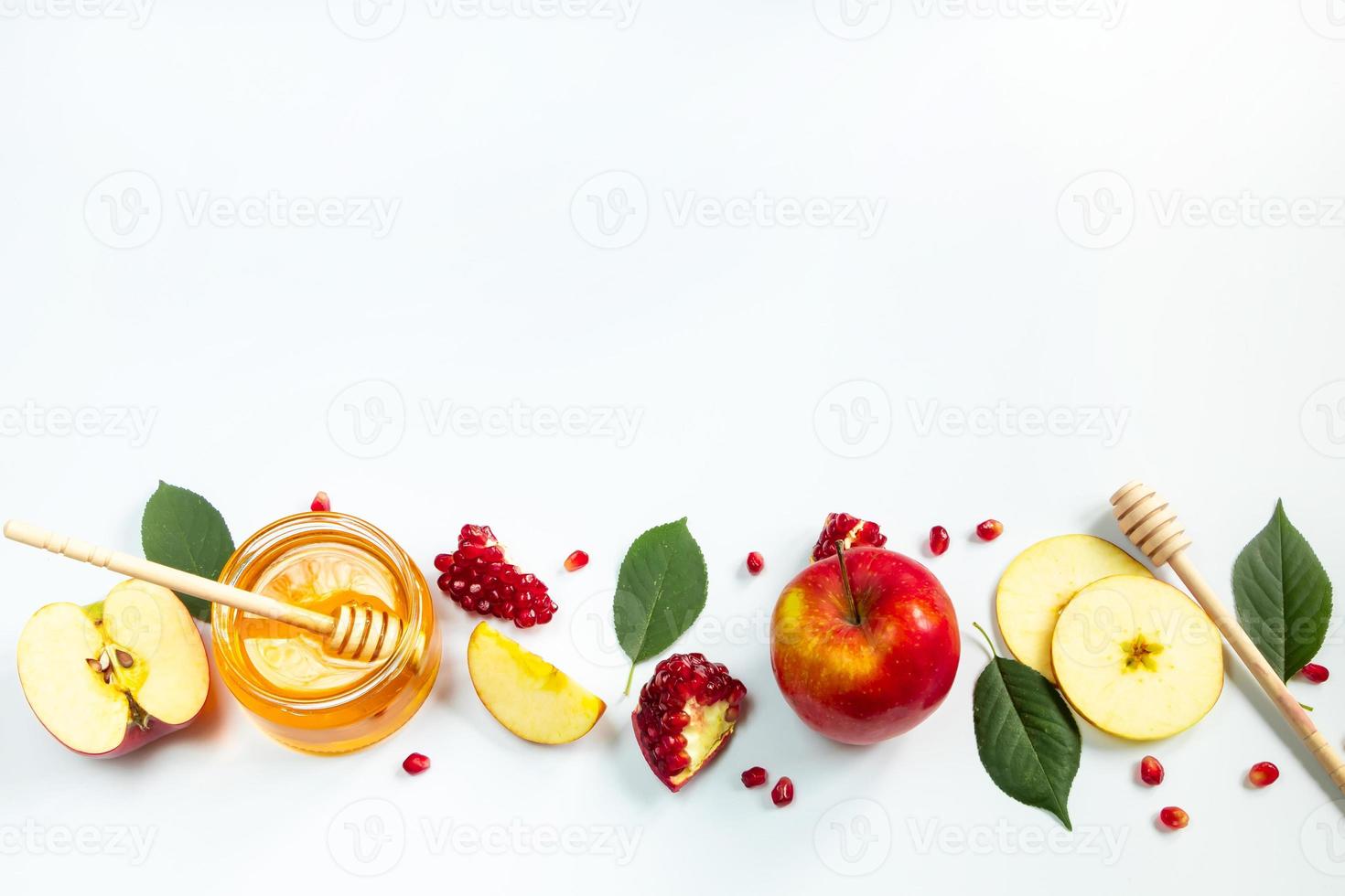 Concept of traditional Jewish holiday of Rosh Hashanah. New Year. Pomegranates, honey and apples on white background. Place for your text. photo