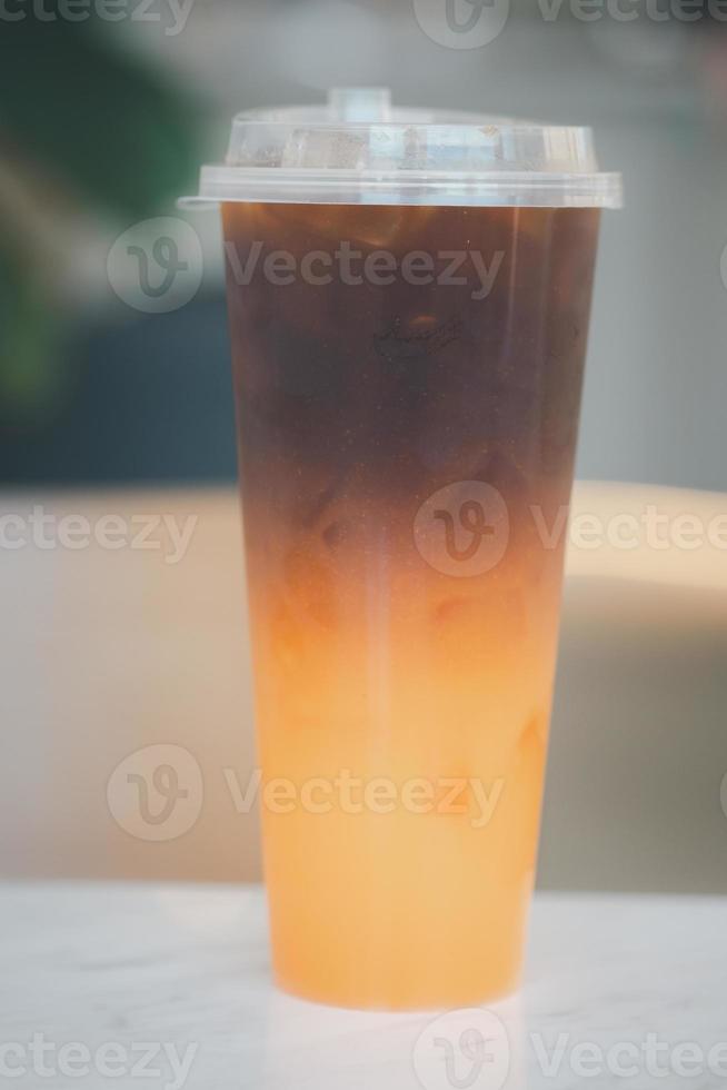 Iced americano black coffee and layer of orange photo