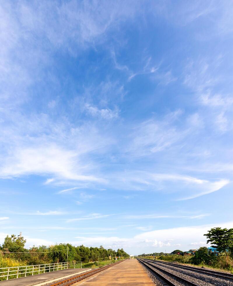 Blue sky with clouds, Sky background image, Platforms and railway tracks at bottom of picture. photo