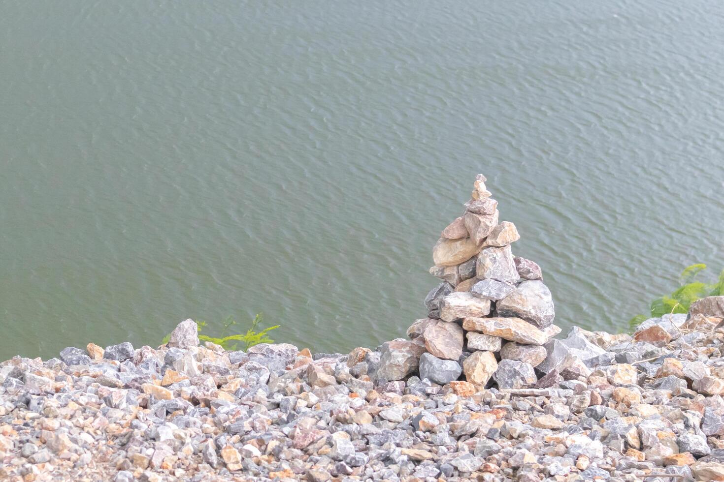 The stones are stacked into layers With river in the background. photo