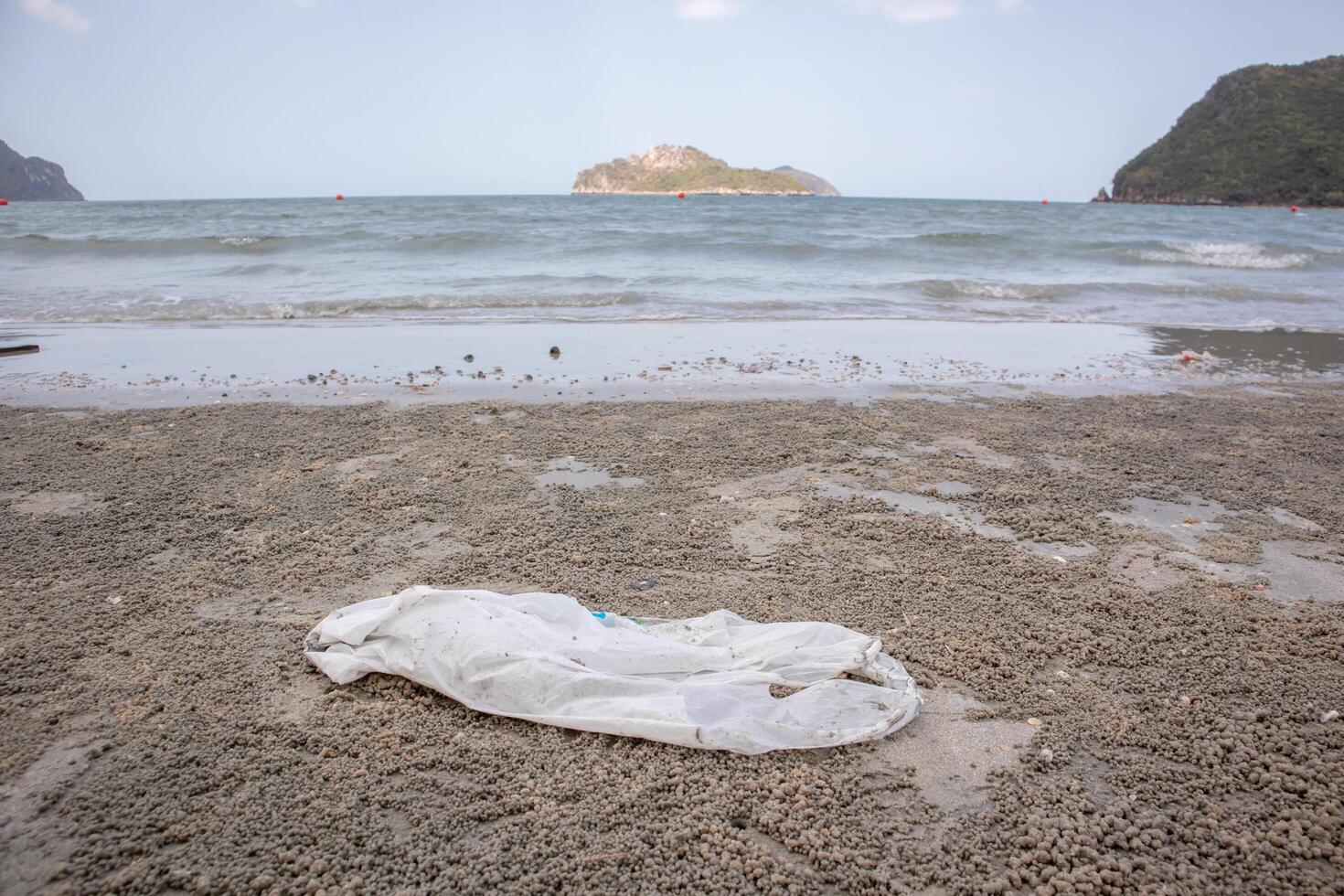 Plastic bag on the beach With sea and sky in the background, Out of focus background photo
