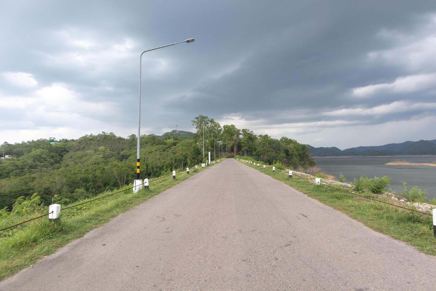 Road on the mountain With mountains, river and sky in the background. photo