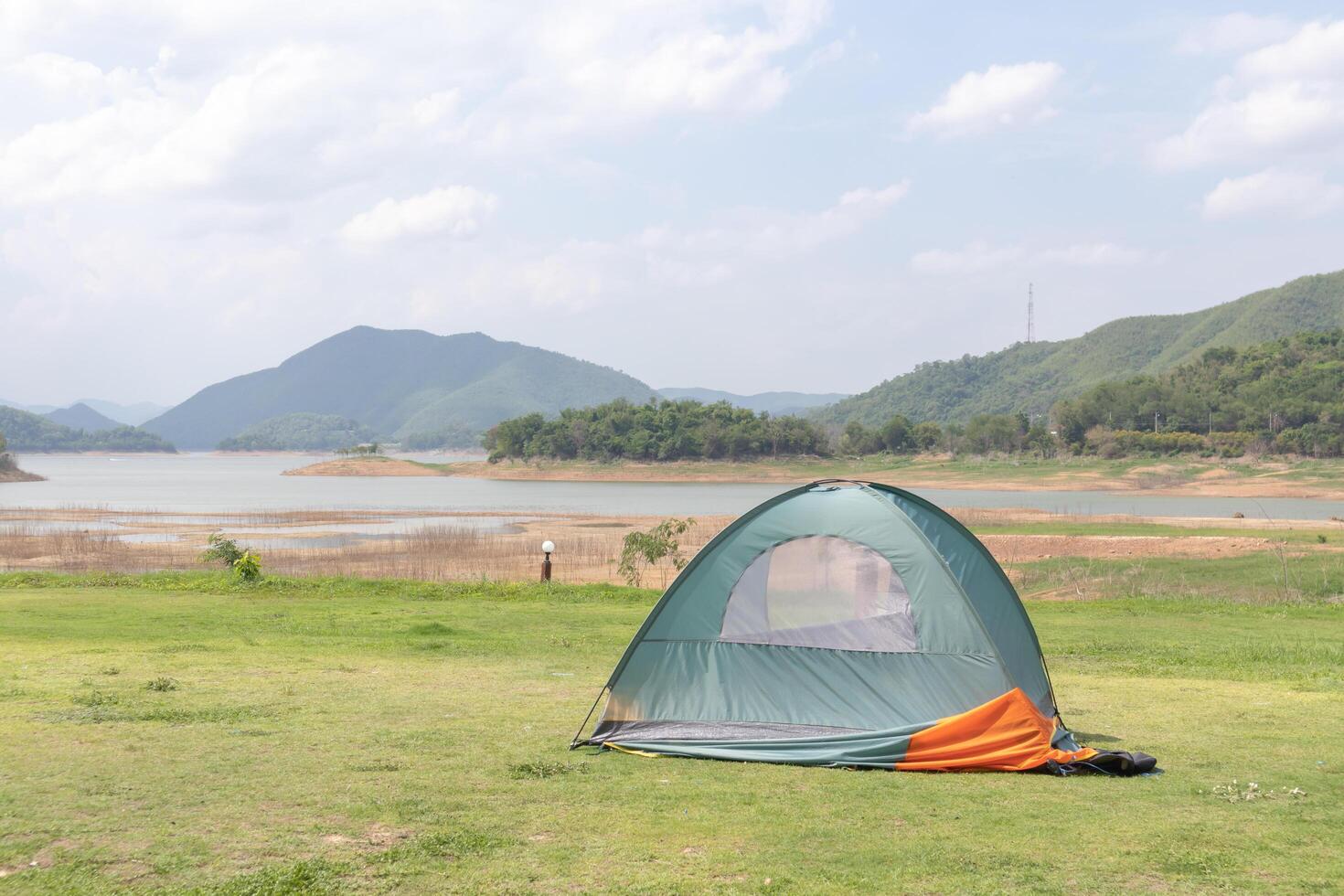 Tent on the lawn With rivers, mountains, and skies in the background photo