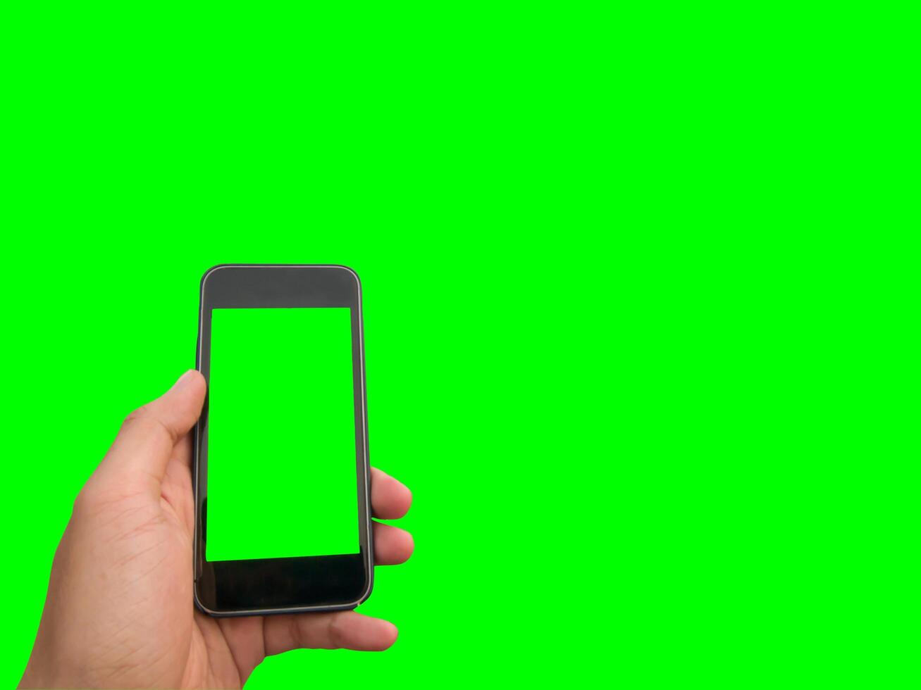 mobile phone in hand with blank screen isolated on green background photo
