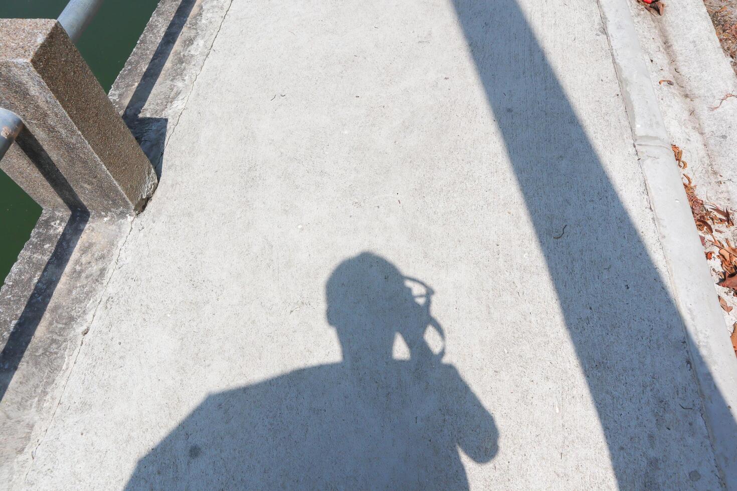 The shadow of a man on the concrete floor. photo