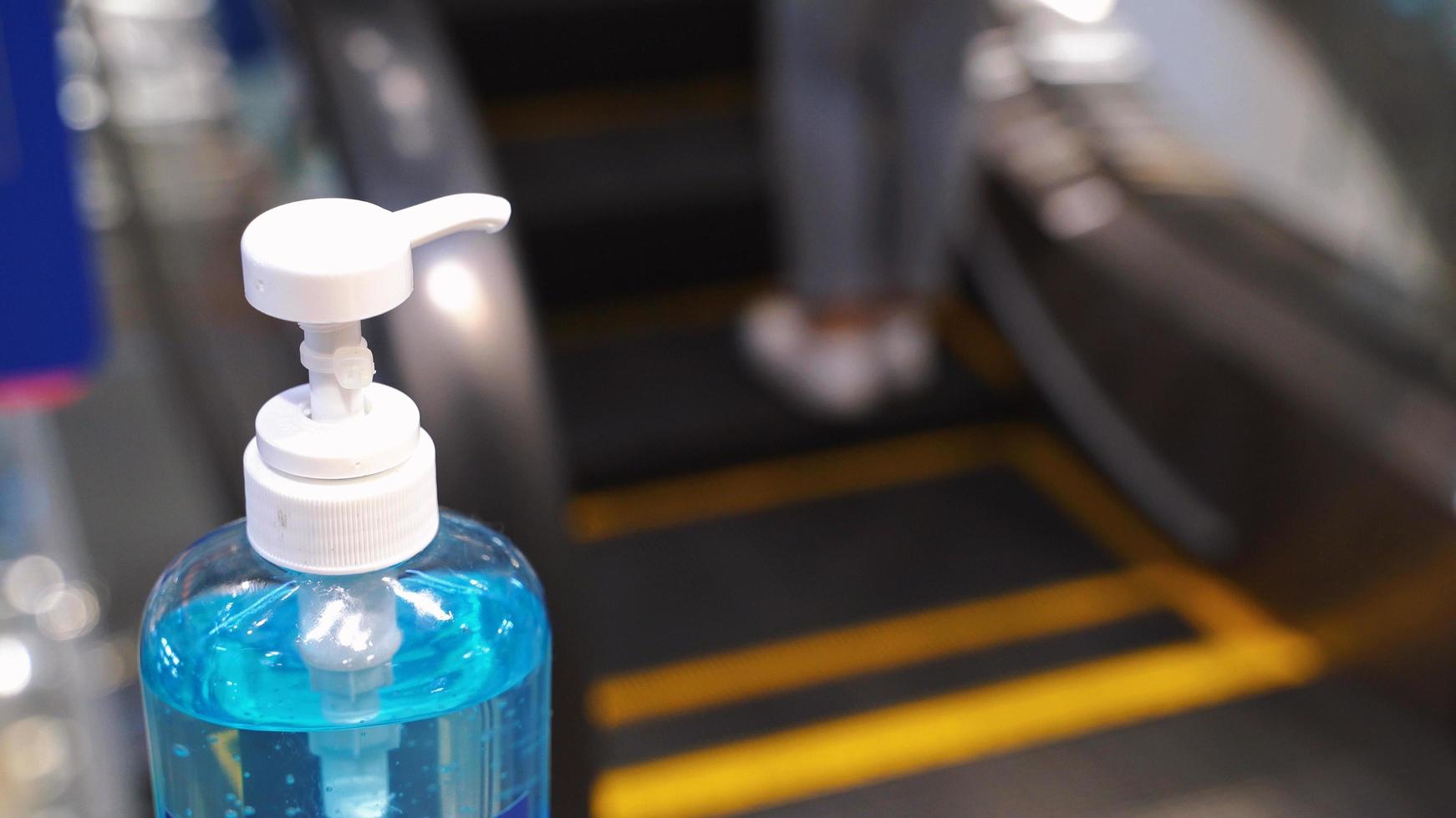 Close up alcohol gel sanitizer at the escalator for prevent the spread of pandemic Covid-19 and Coronavirus, healthcare and hygiene concept photo