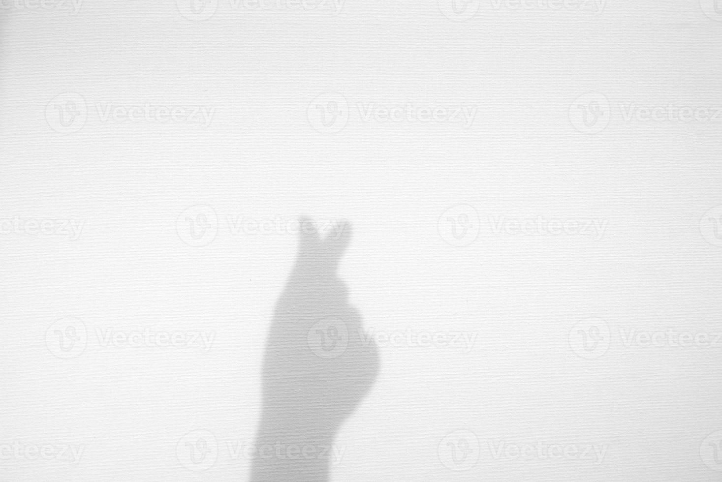 Realistic hand do as a symbol love shape in mini heart shadow overlay effect on white texture background, valentines day and love concept photo