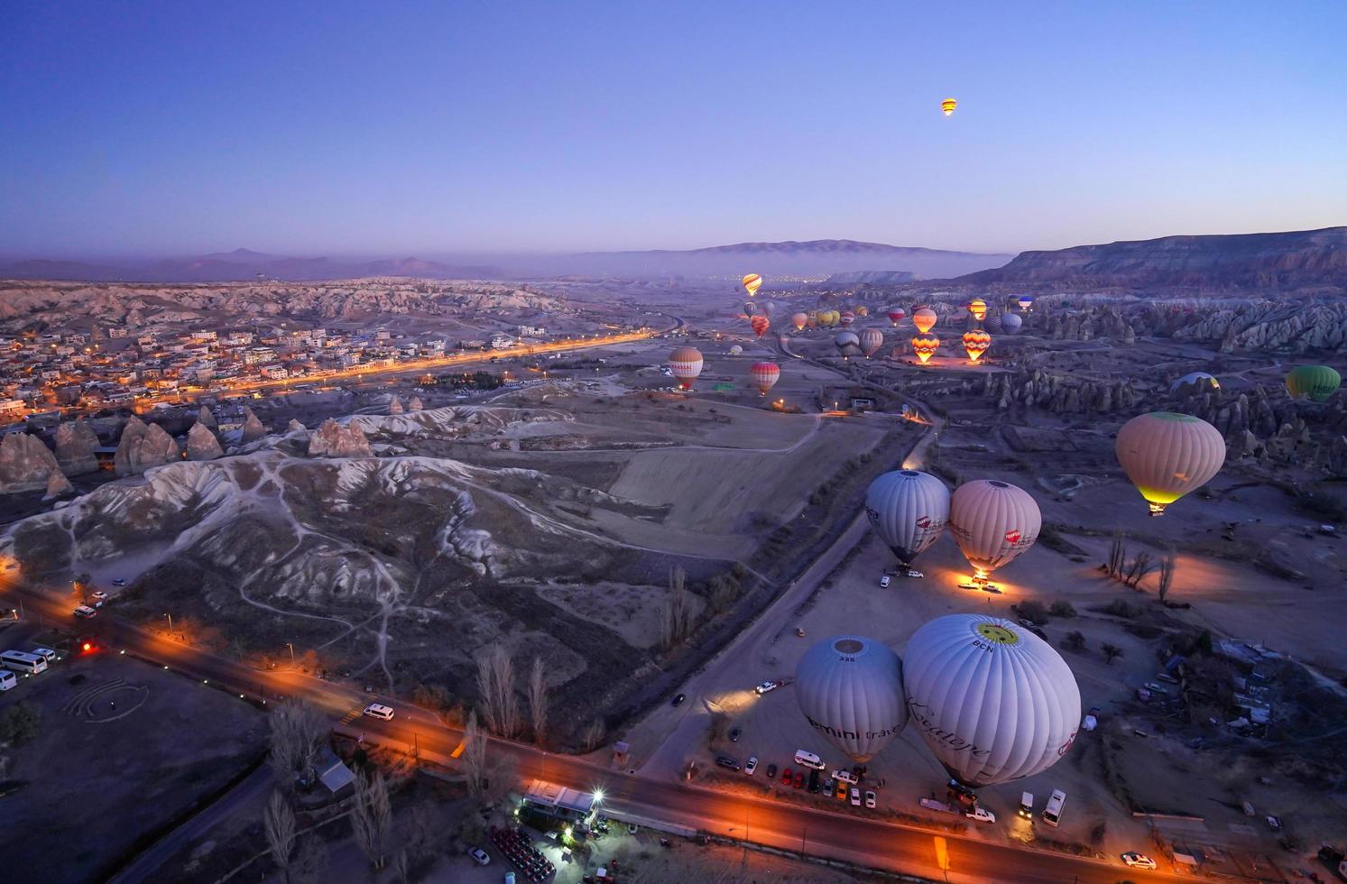 Aerial beautiful landscape view of balloons flight in the morning twilight sky background photo