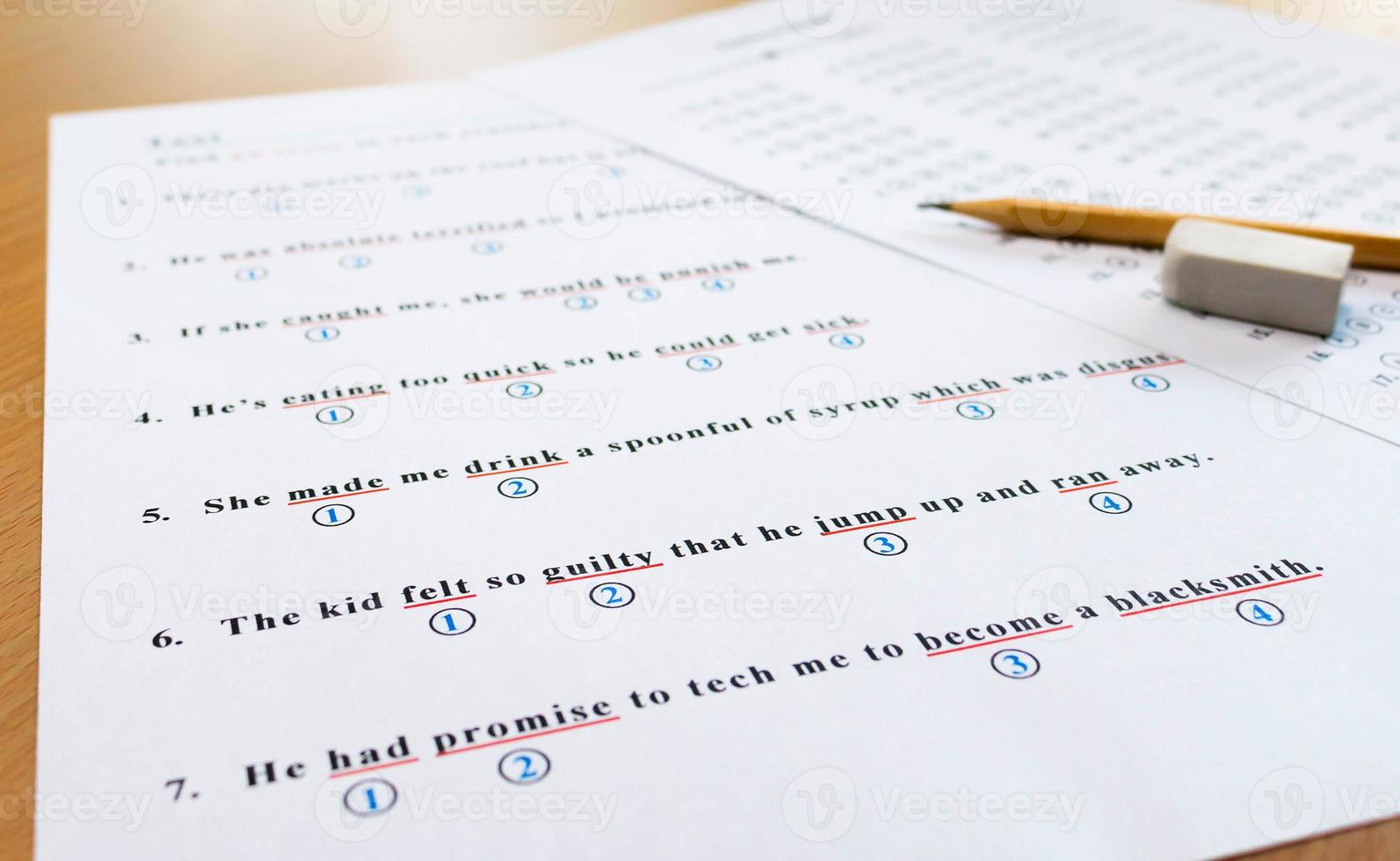 english test and answer sheet on table photo