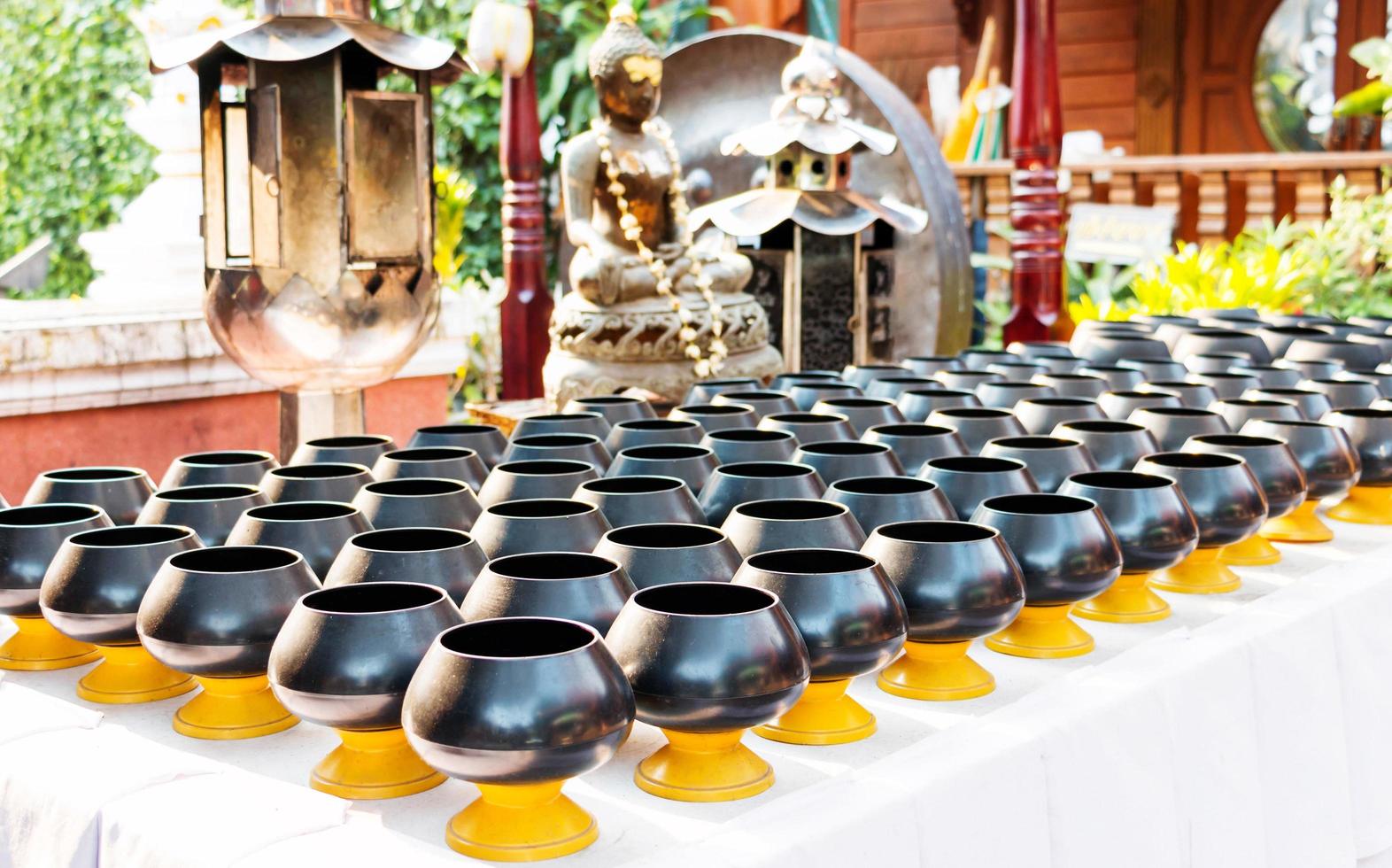 black monk's alms bowls on table photo