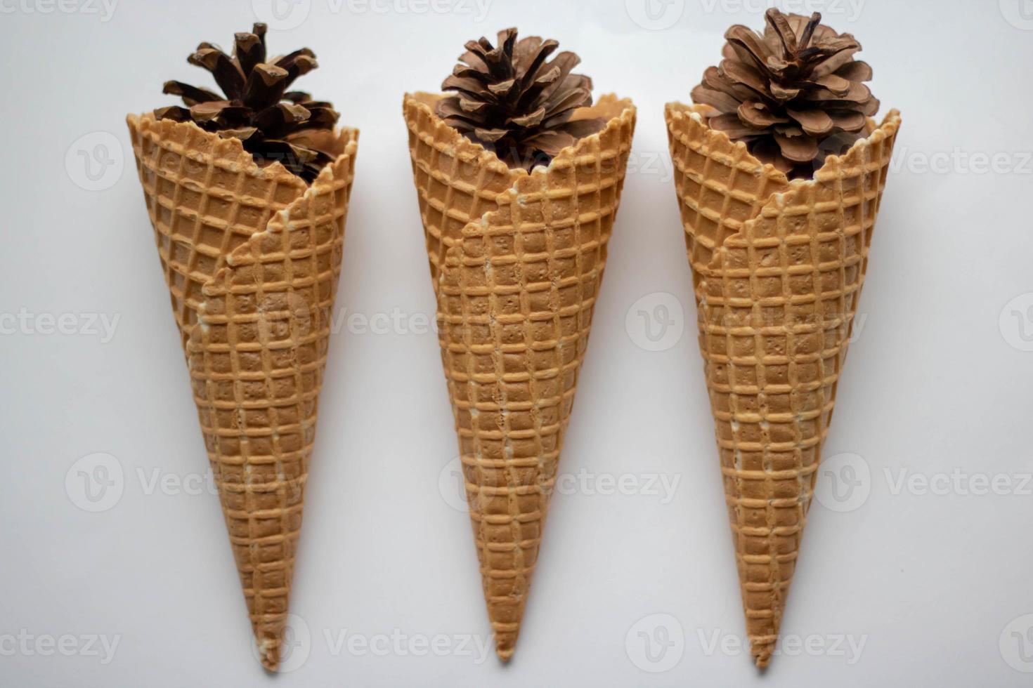Pine cones in a waffle cone on white background photo