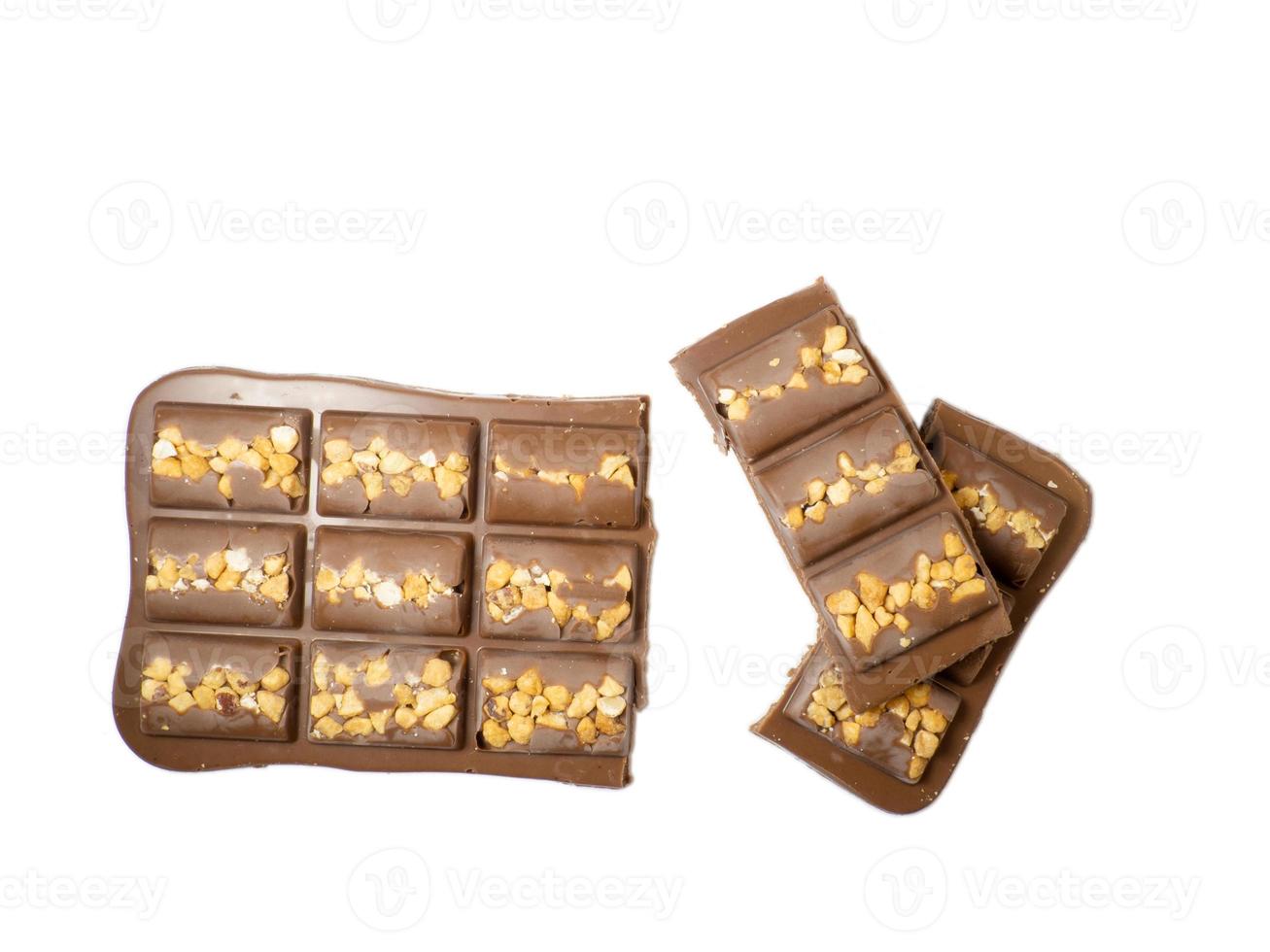 Milk chocolate bar with nuts on a white background. photo
