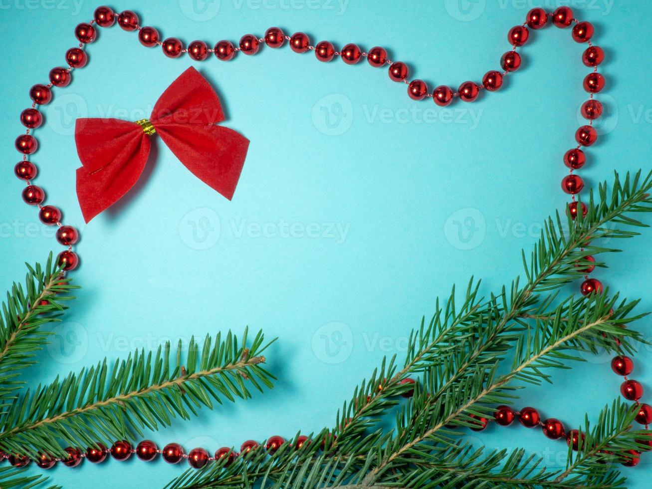 New Year card. Christmas card on a blue background. Fir branches.  Christmas toys. Red bows photo