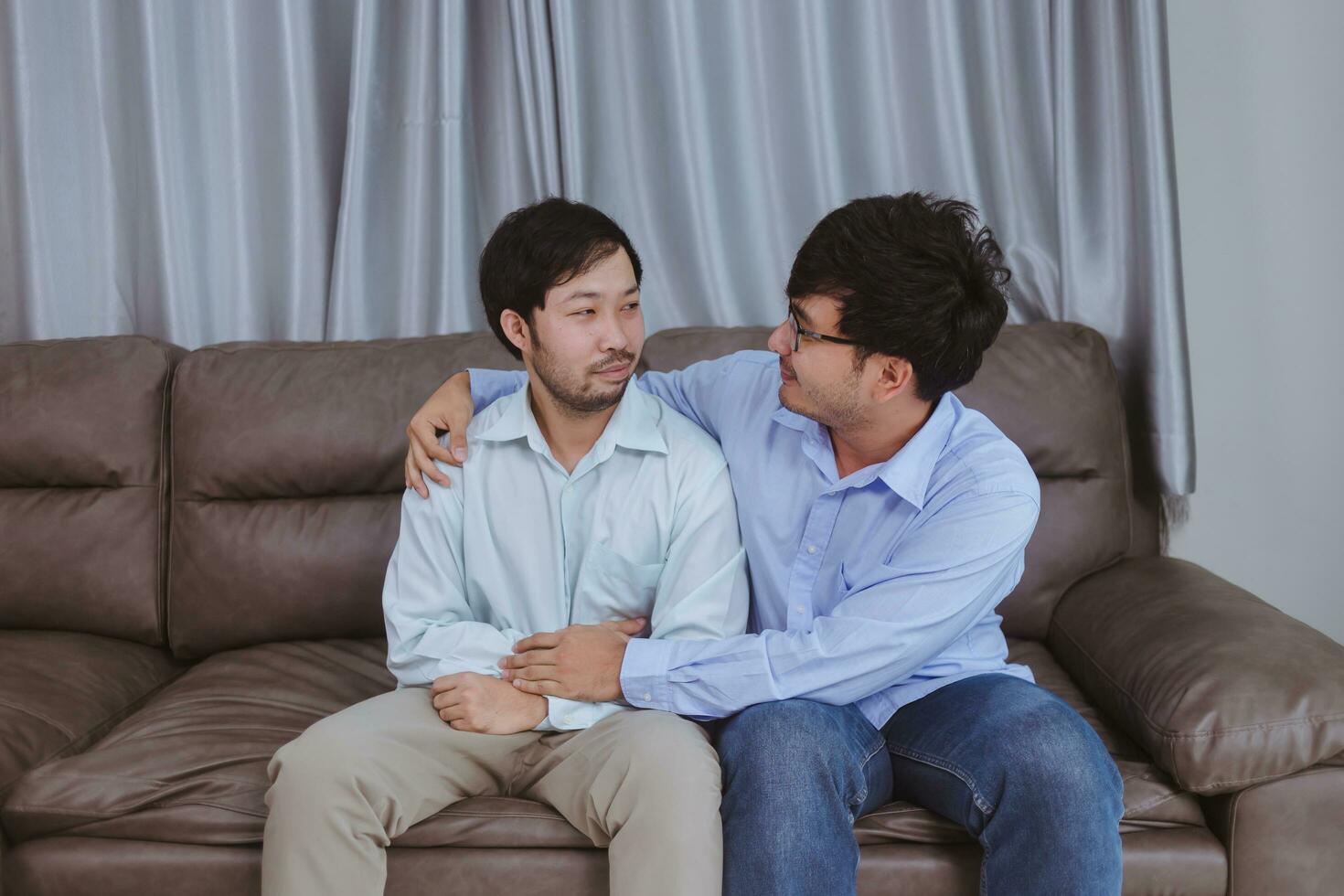 An asian young gay men couples showing some love affection, sharing a special feeling, arms around each other, happy to be together. photo