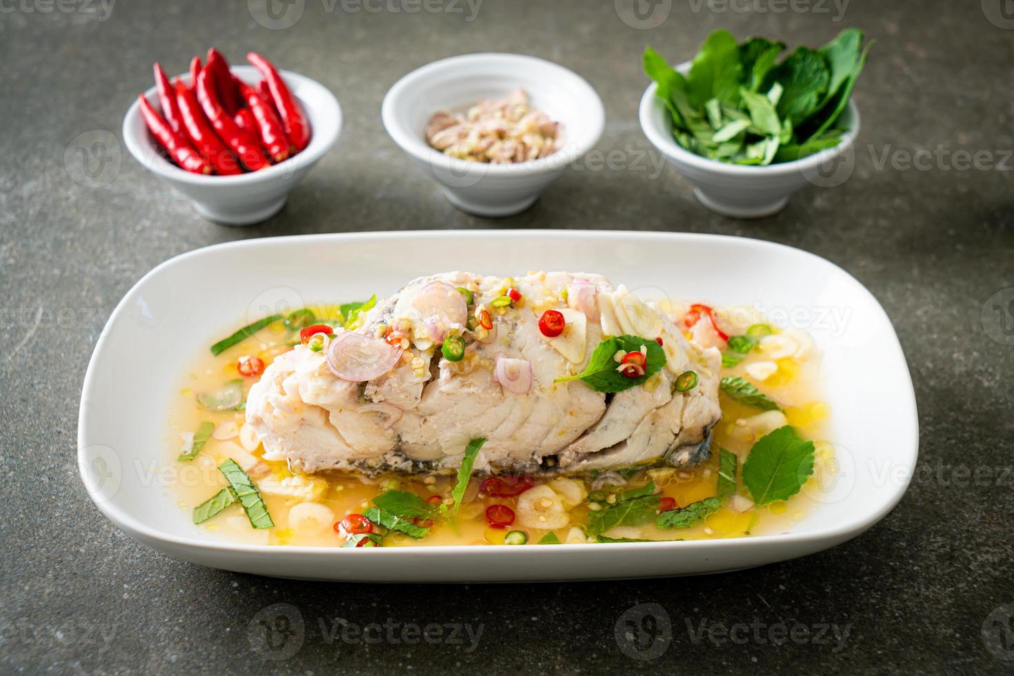 steamed sea bass fish with herbs photo