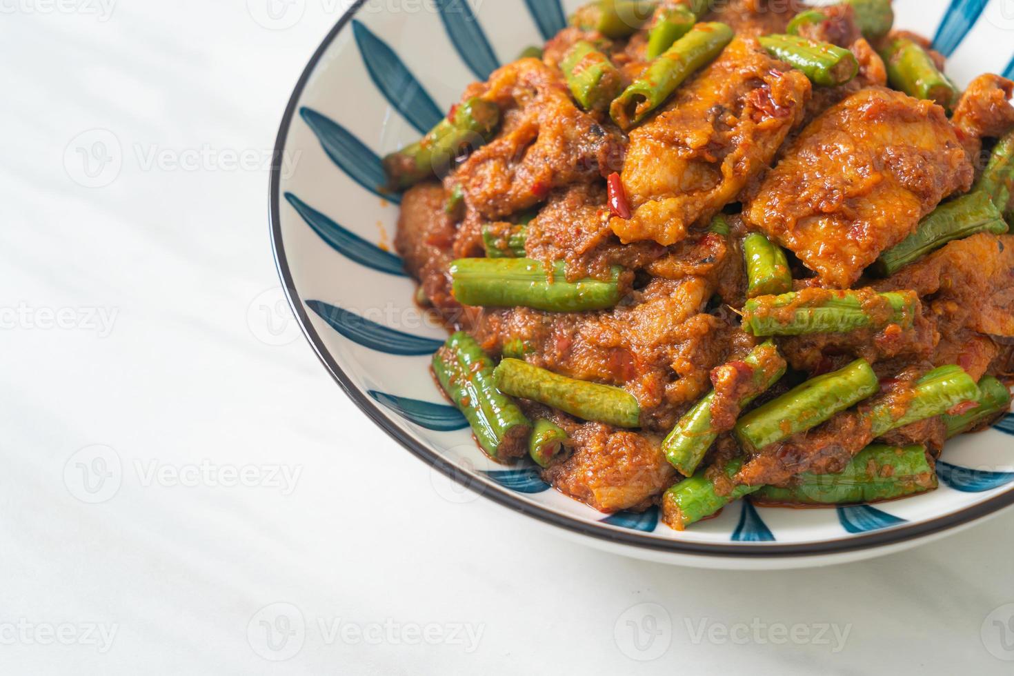 Stir fried pork with red curry paste photo