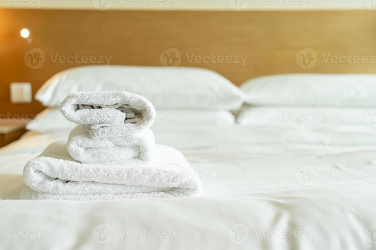close-up white towel on bed photo