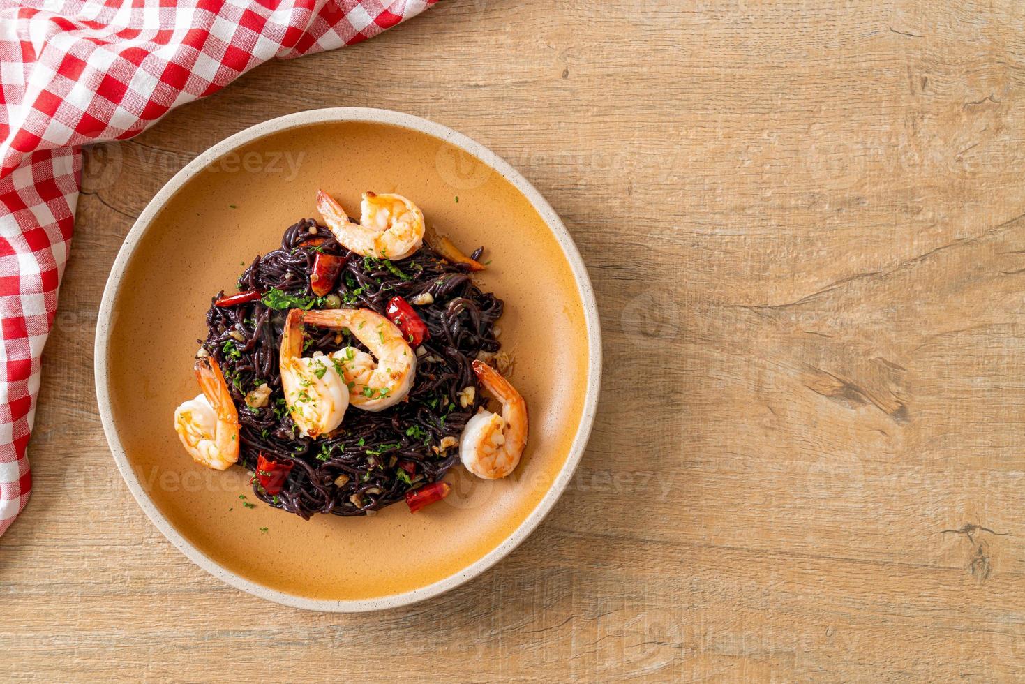 stir-fried black spaghetti with garlic and shrimps photo