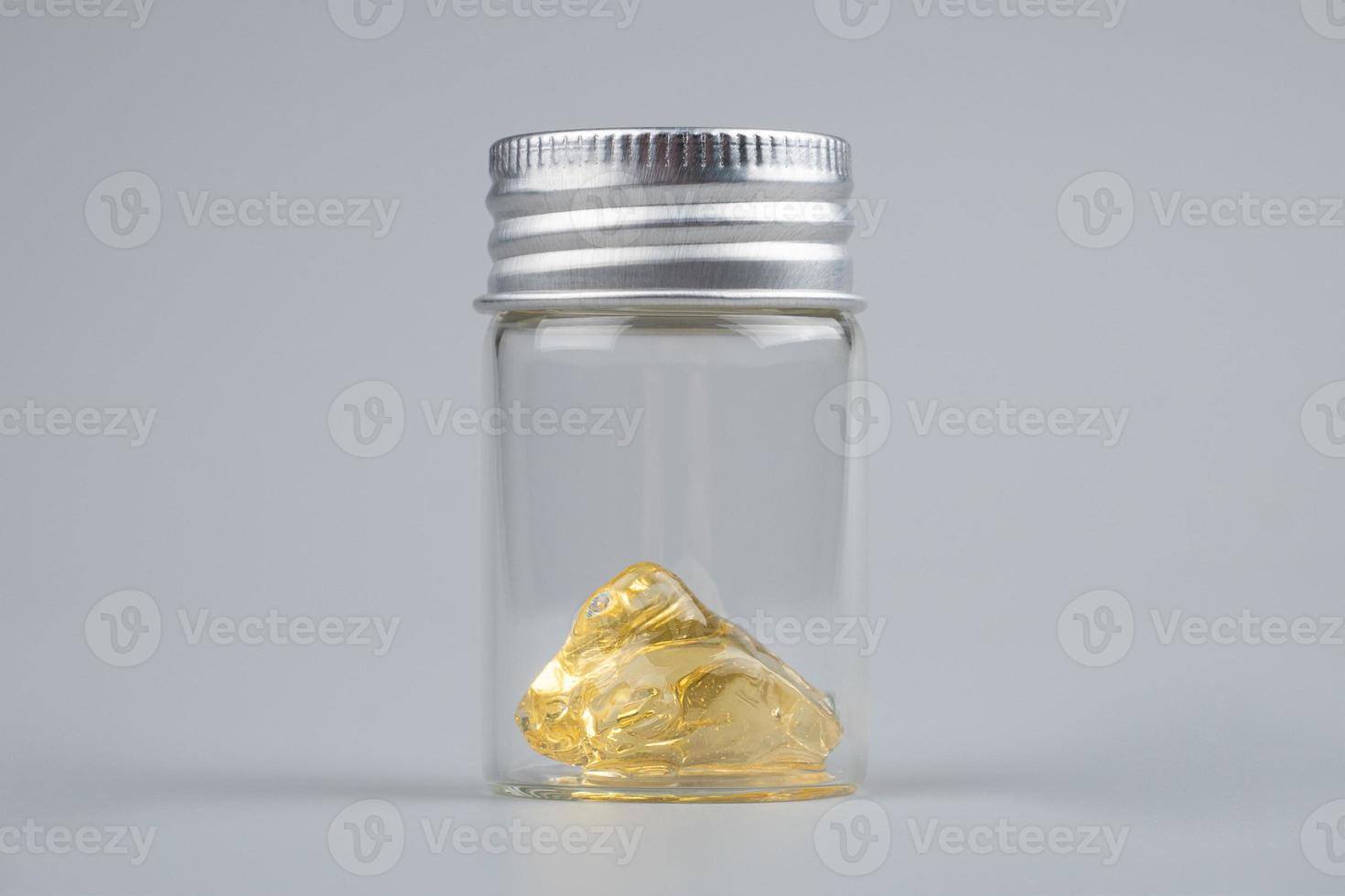 piace cannabis extract wax with transparent bottle closeup on gray background photo