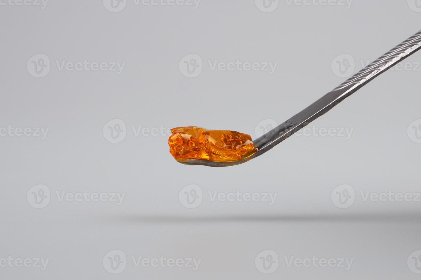 detail of resin wax of marijuana concentrate on dabbing tool photo