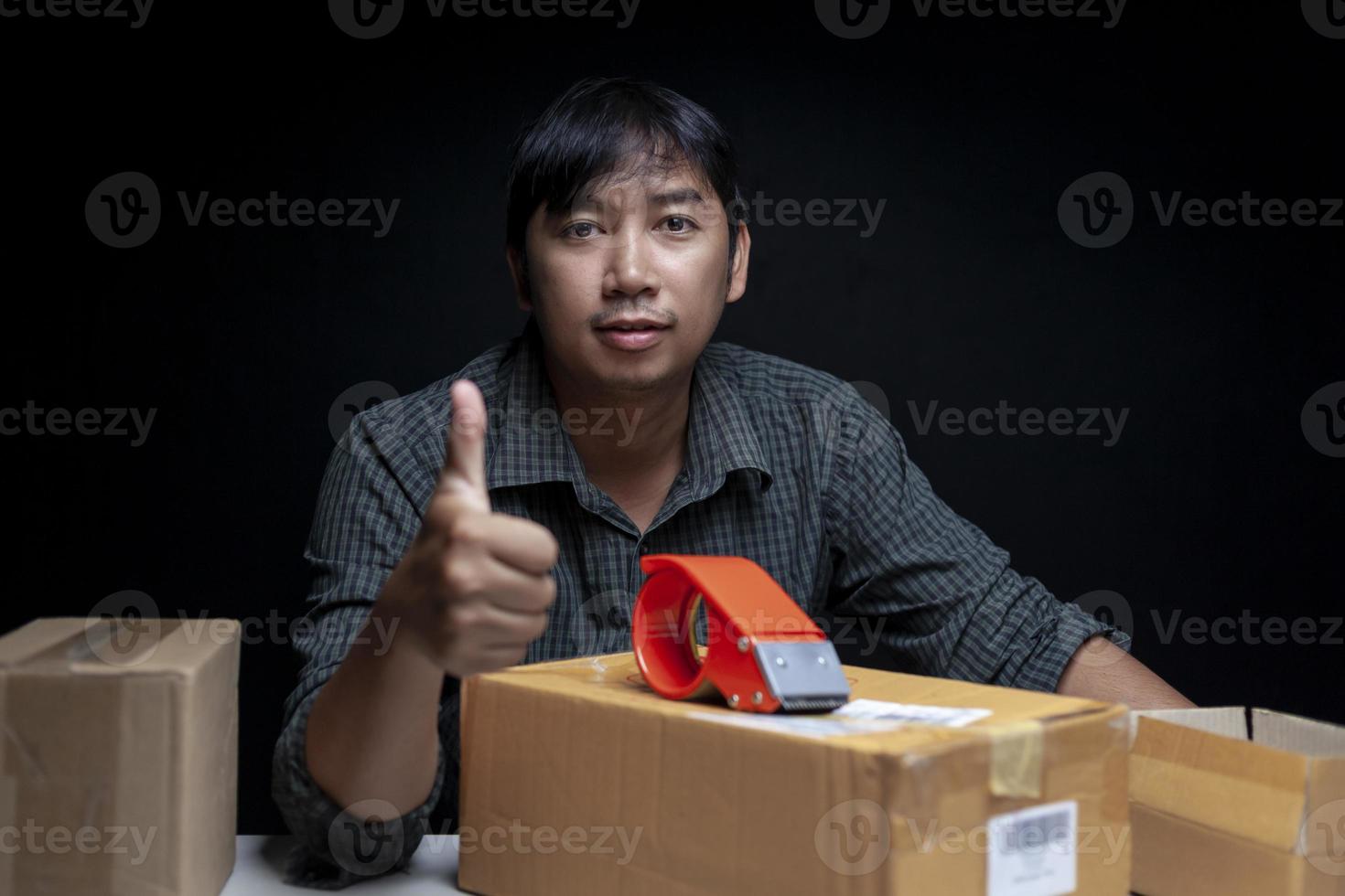 man doing thumbs up gesture Show satisfaction with starting an online trading business. photo