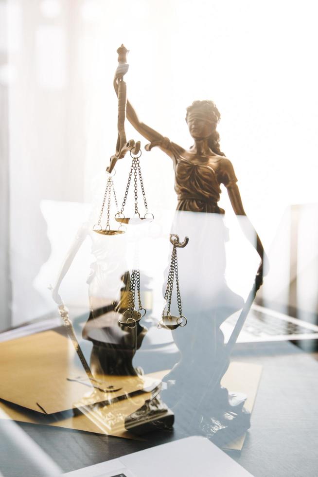 Business and lawyers discussing contract papers with brass scale on desk in office. Law, legal services, advice, justice and law concept picture with film grain effect photo