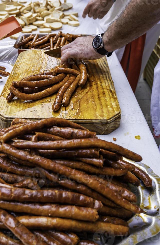 Cutting fried sausage photo