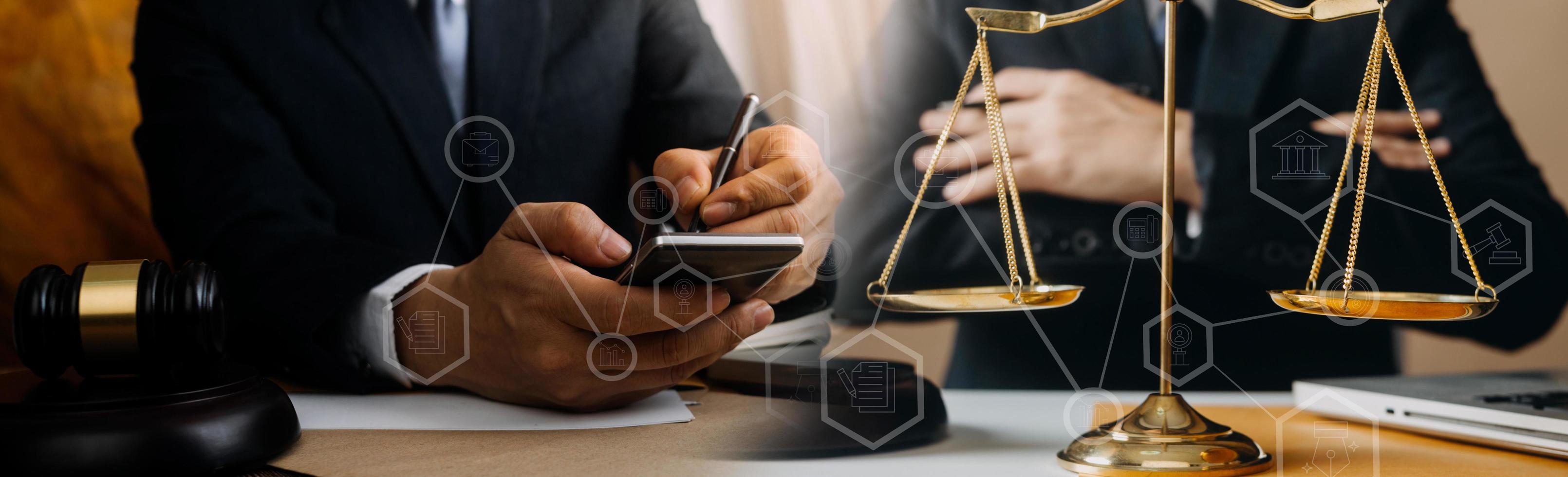 Business and lawyers discussing contract papers with brass scale on desk in office. Law, legal services, advice, justice and law concept picture with film grain effect photo