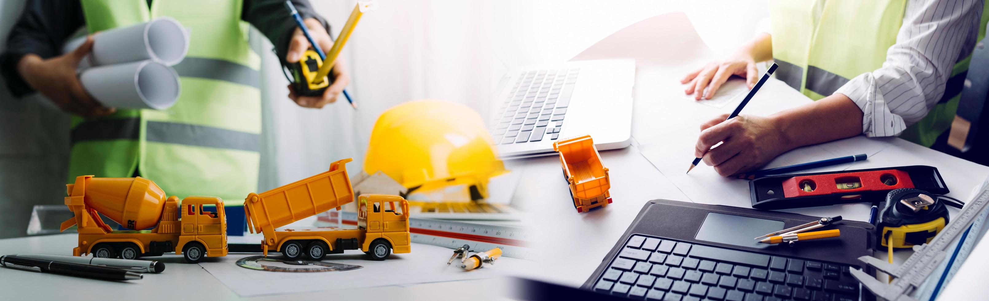 business hand working and laptop with on on architectural project at construction site at office desk in office photo