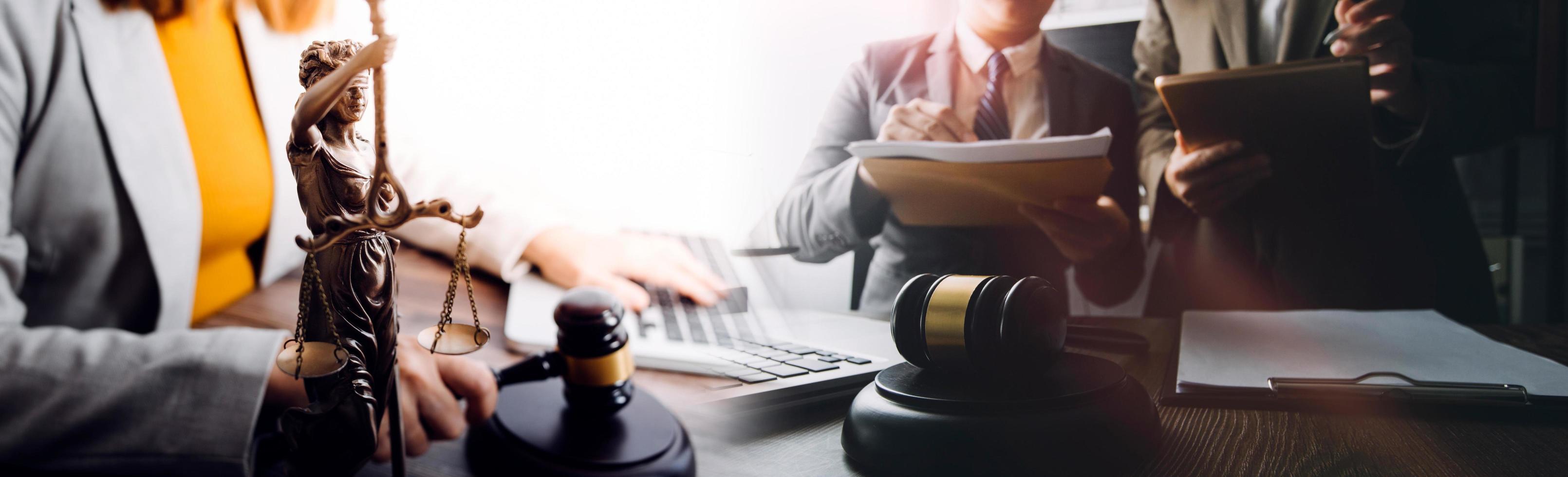 Business and lawyers discussing contract papers with brass scale on desk in office. Law, legal services, advice, justice and law concept picture with film grain effect photo