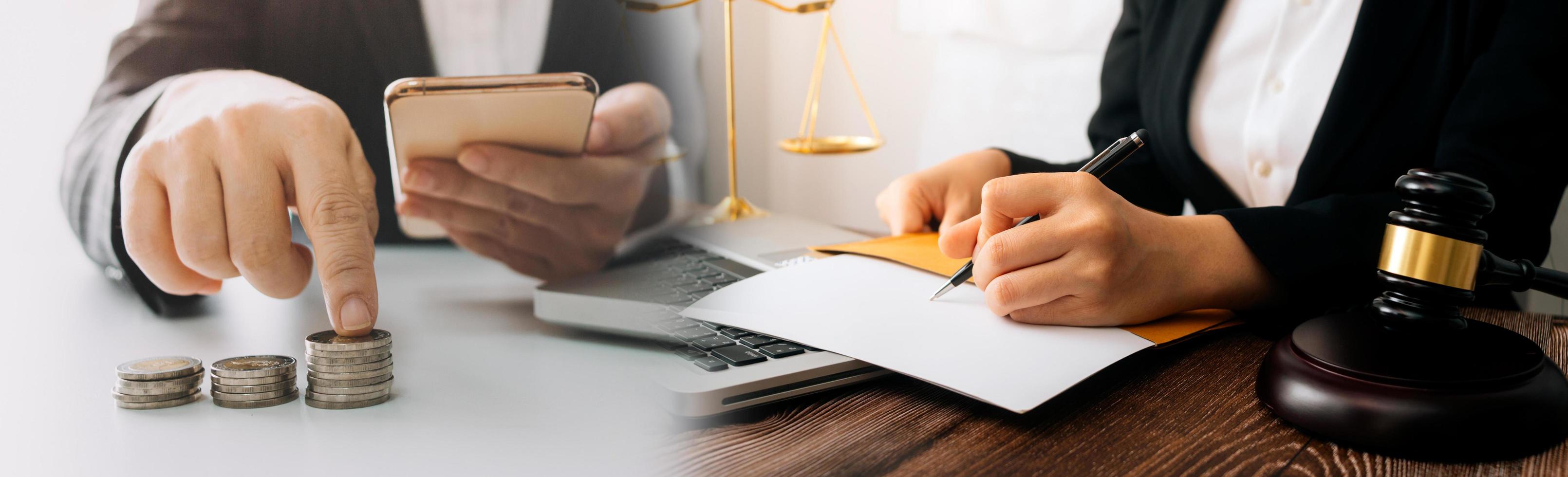 Justice and law concept.Male judge in a courtroom with the gavel, working with, computer and docking keyboard, eyeglasses, on table in morning light photo