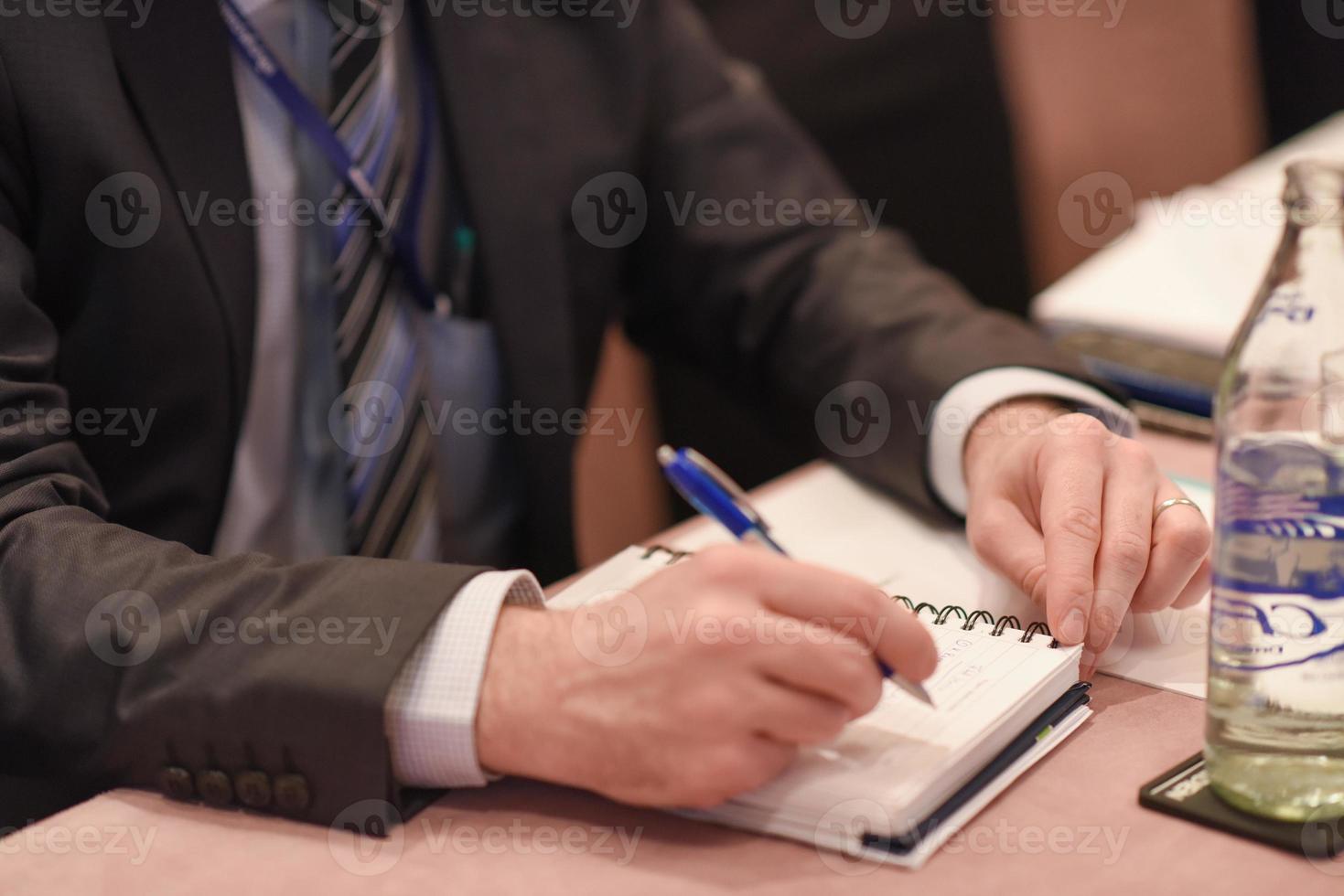 Close-up of woman hand making notes photo