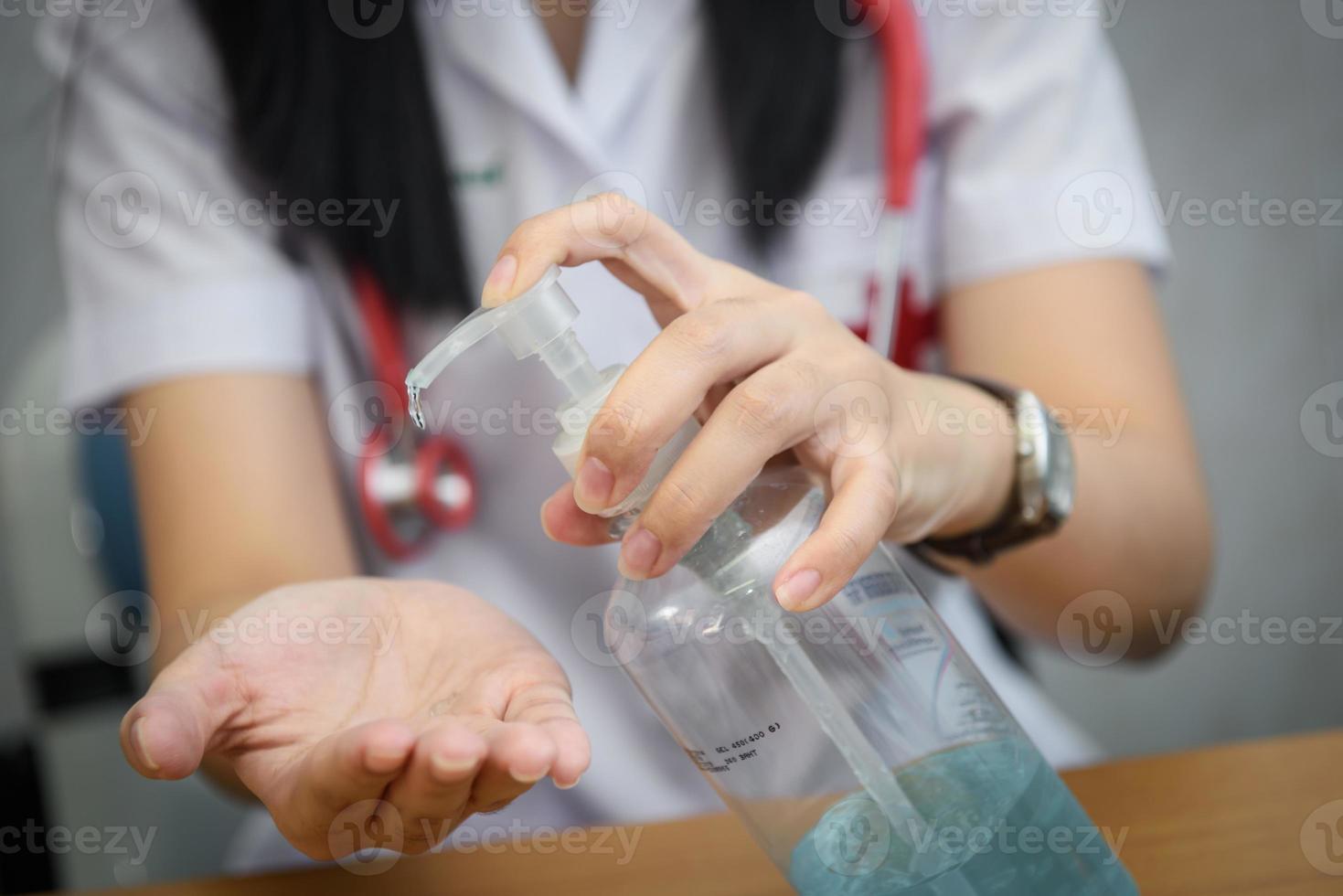 Medical doctor using sanitizer dispenser photo