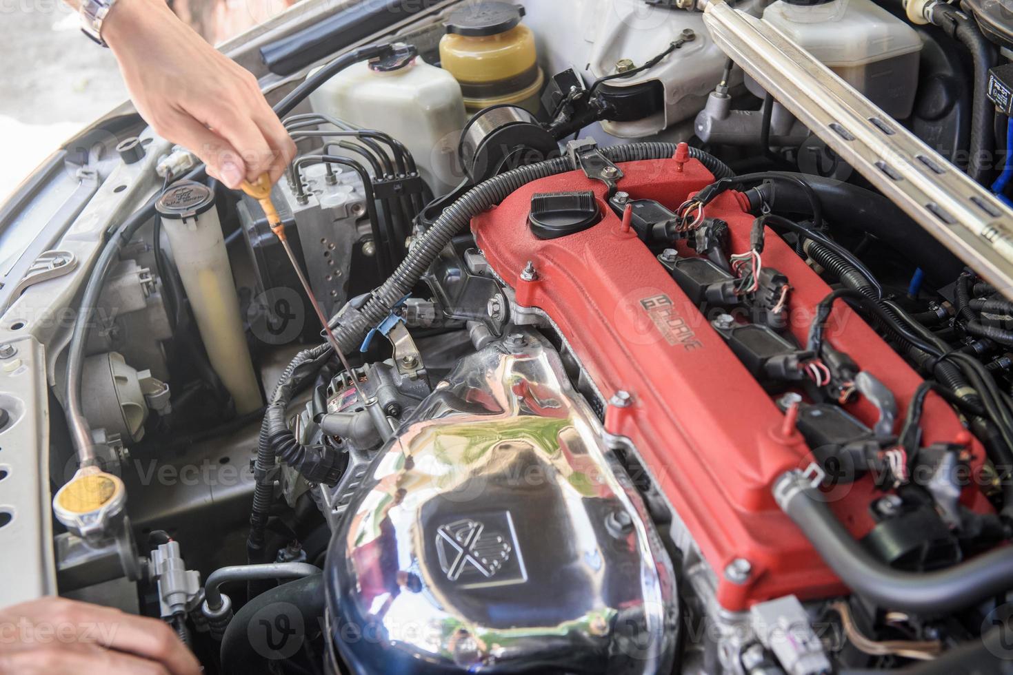 A man checking car engine photo