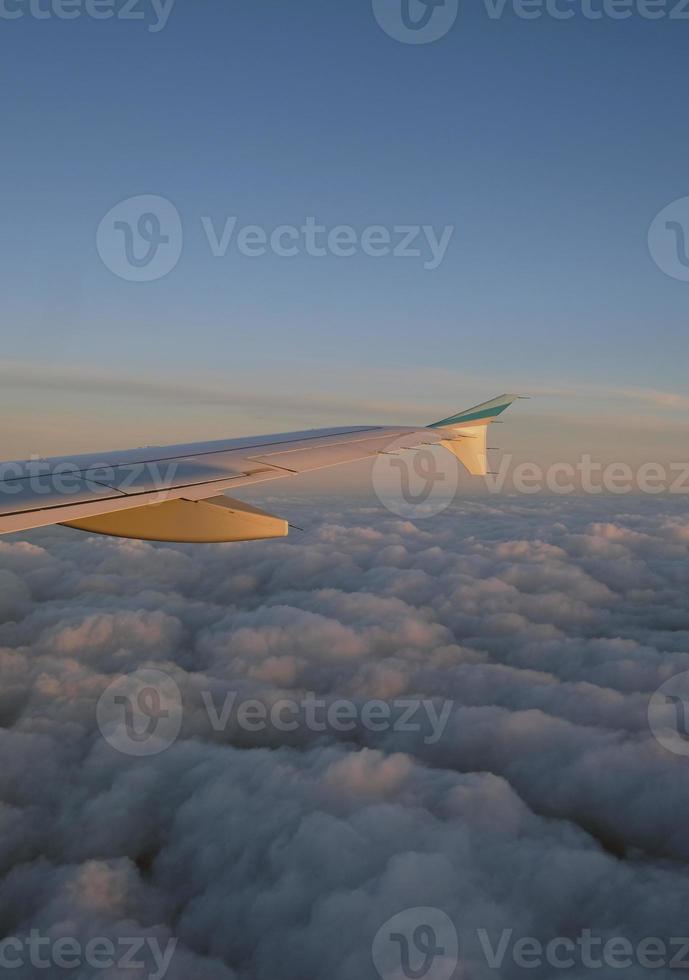 Beautiful view over the clouds from a plane window photo