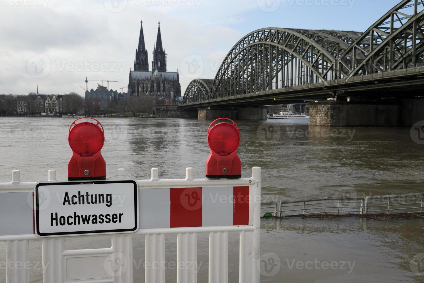 Extreme weather - Warning sign in German at the entrance to a flooded pedestrian zone in Cologne, Germany photo