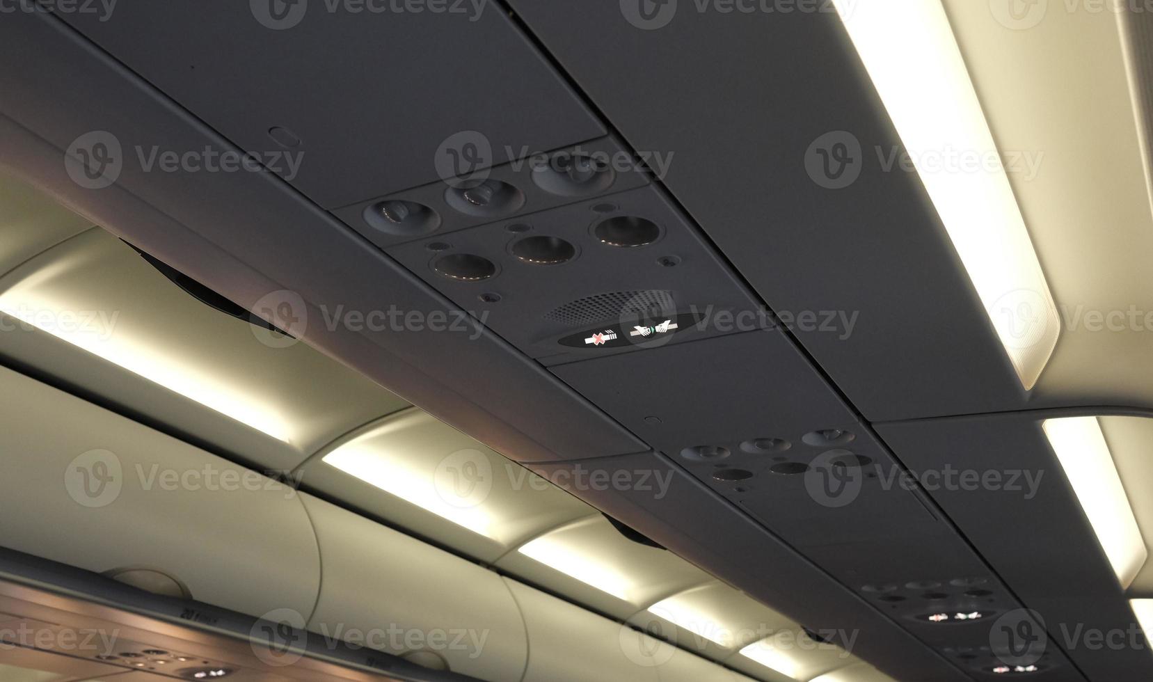 Overhead panel with lights and ventilation on an airplane photo
