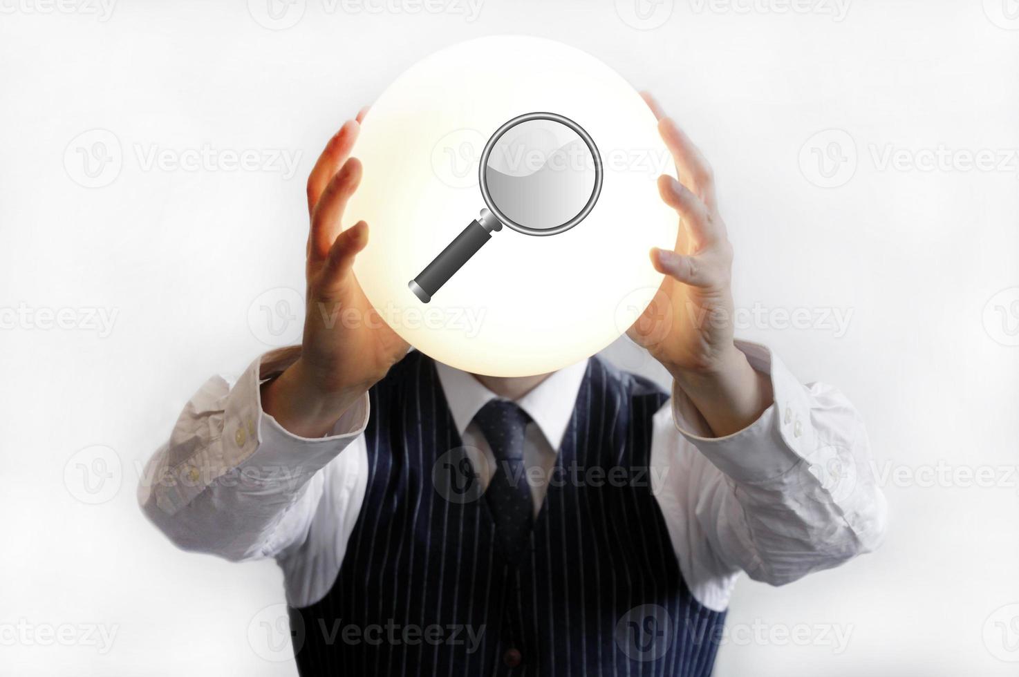 Businessman holding bright sign with magnifying glass photo