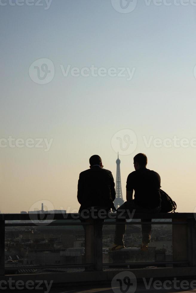 Silhouette of two people enjoying a sunset in Paris, France photo