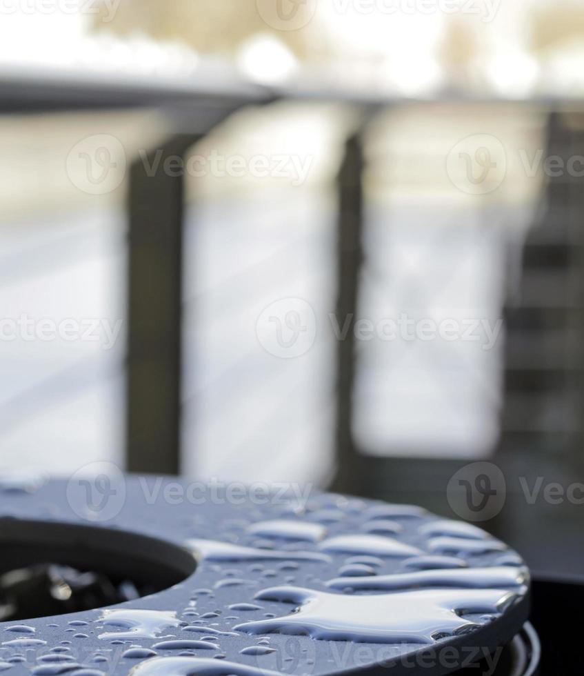 Close-up of rain drops on a metal surface photo