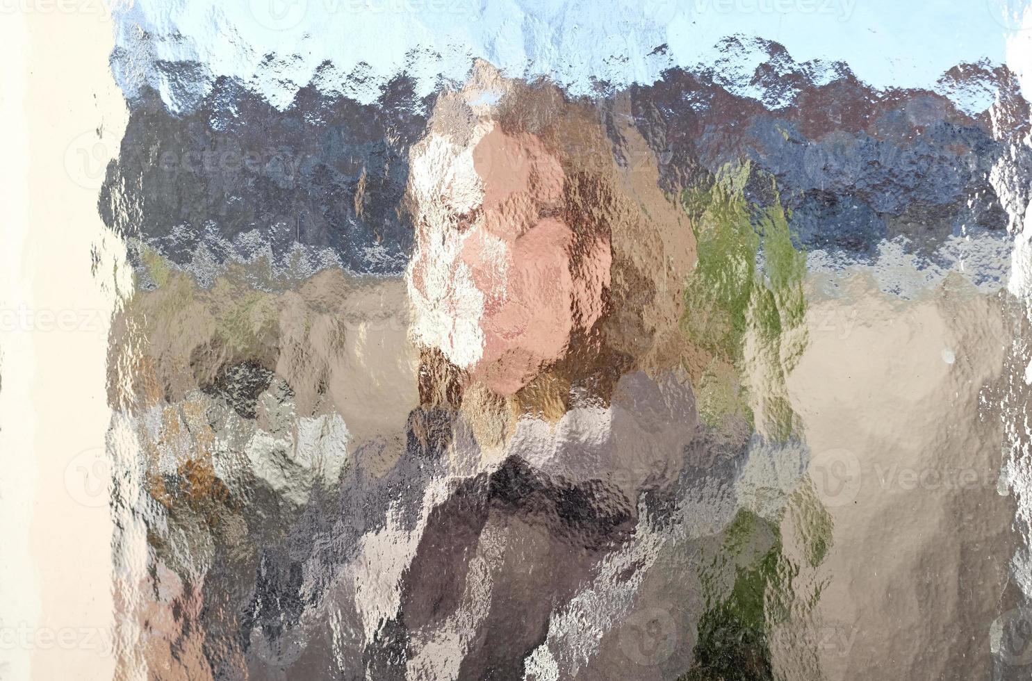 Face of a woman distorted by a window photo