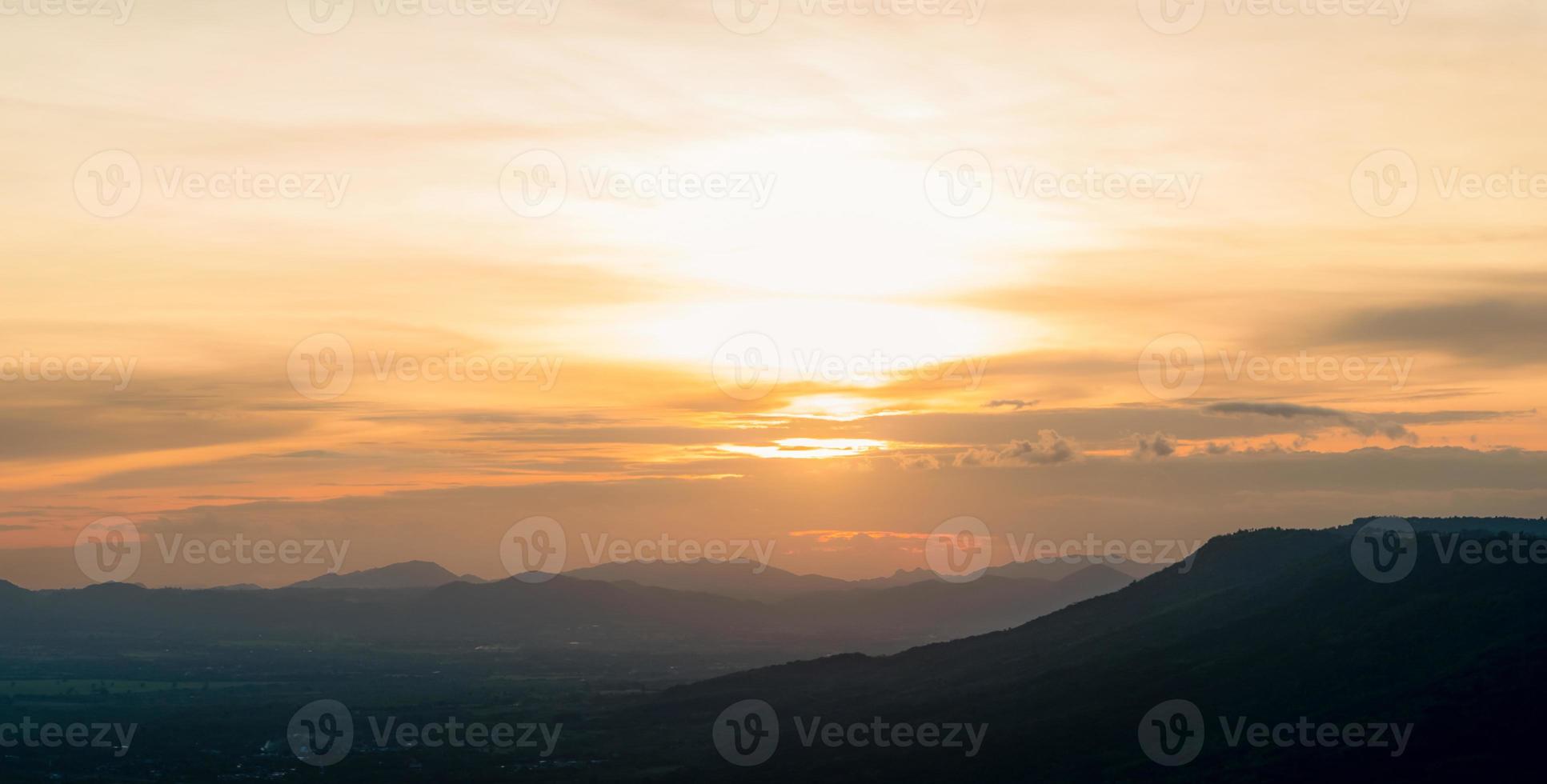 Landscape of mountain range with sunset sky. Mountain at dusk. Orange sky and clouds at sunset. Mountain valley. Mountain layer at dusk. Beauty in nature. Tranquility scene. Beautiful sunset sky. photo
