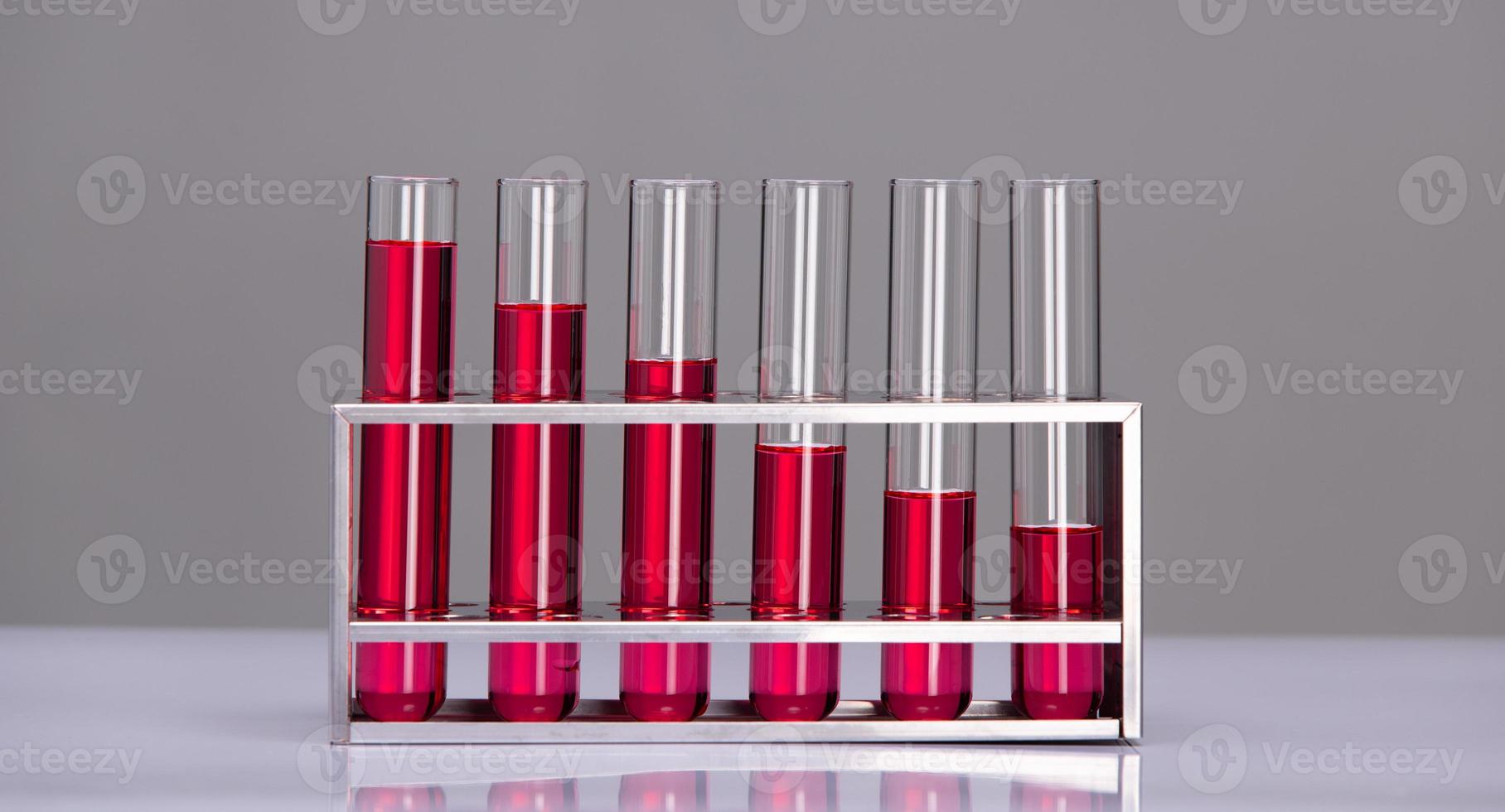 Lab tubes Growth Concept. Several glass tubes on rack with increasing amount of liquid in consecutive tube. Metaphor compare as Science investment research and development bar chart photo