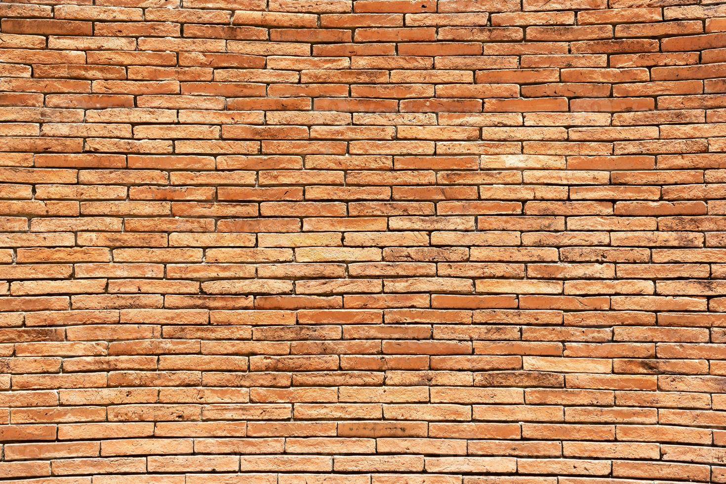 Red brick wall background. A wall of old, cracked bricks, with a weathered and faded surface. Restored brickwork of an old house. photo
