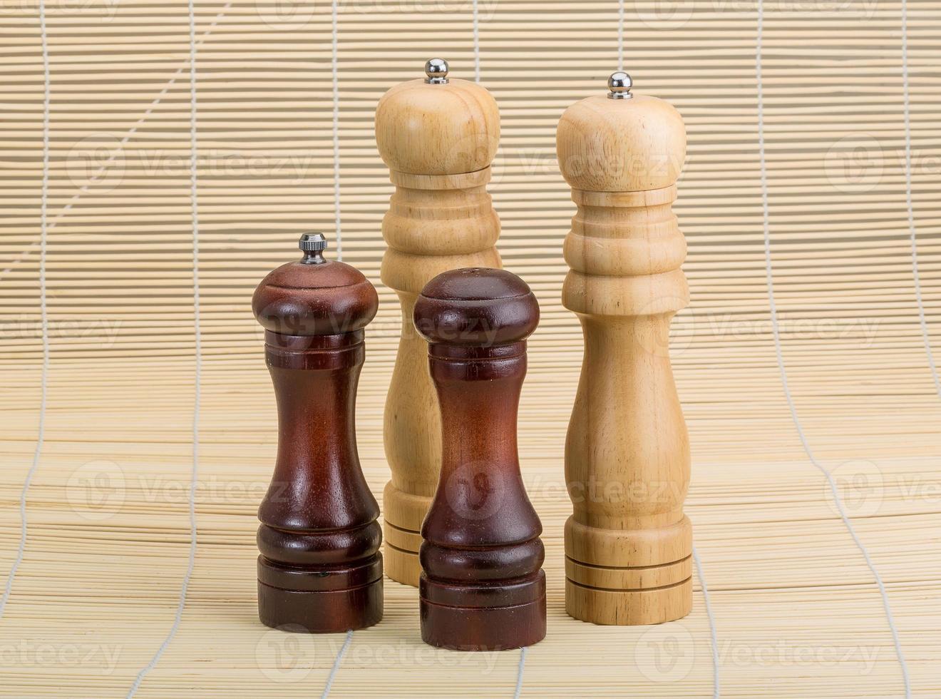 Pepper mill on wooden background photo