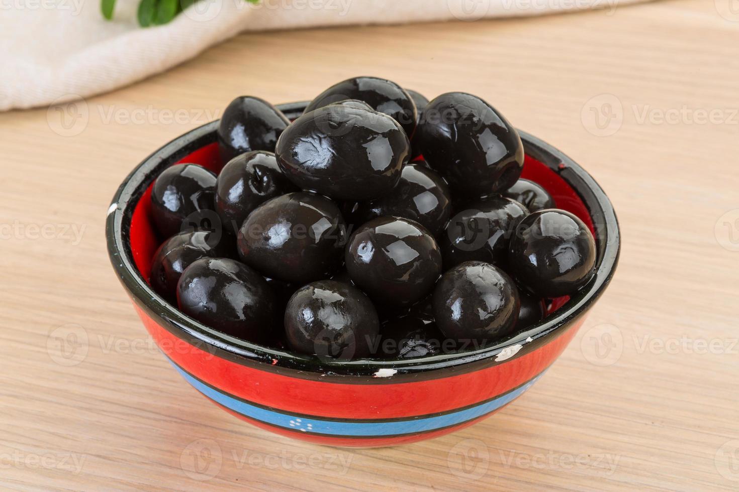 Black olives in a bowl on wooden background 11716316 Stock Photo at
