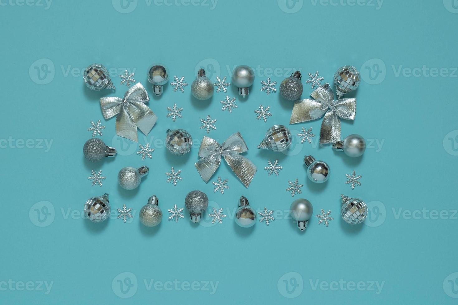 Merry Christmas and Happy Holidays postcard, frame, banner. New Year. Noel. Silver decor on a blue background top view. Winter Christmas holiday theme. photo