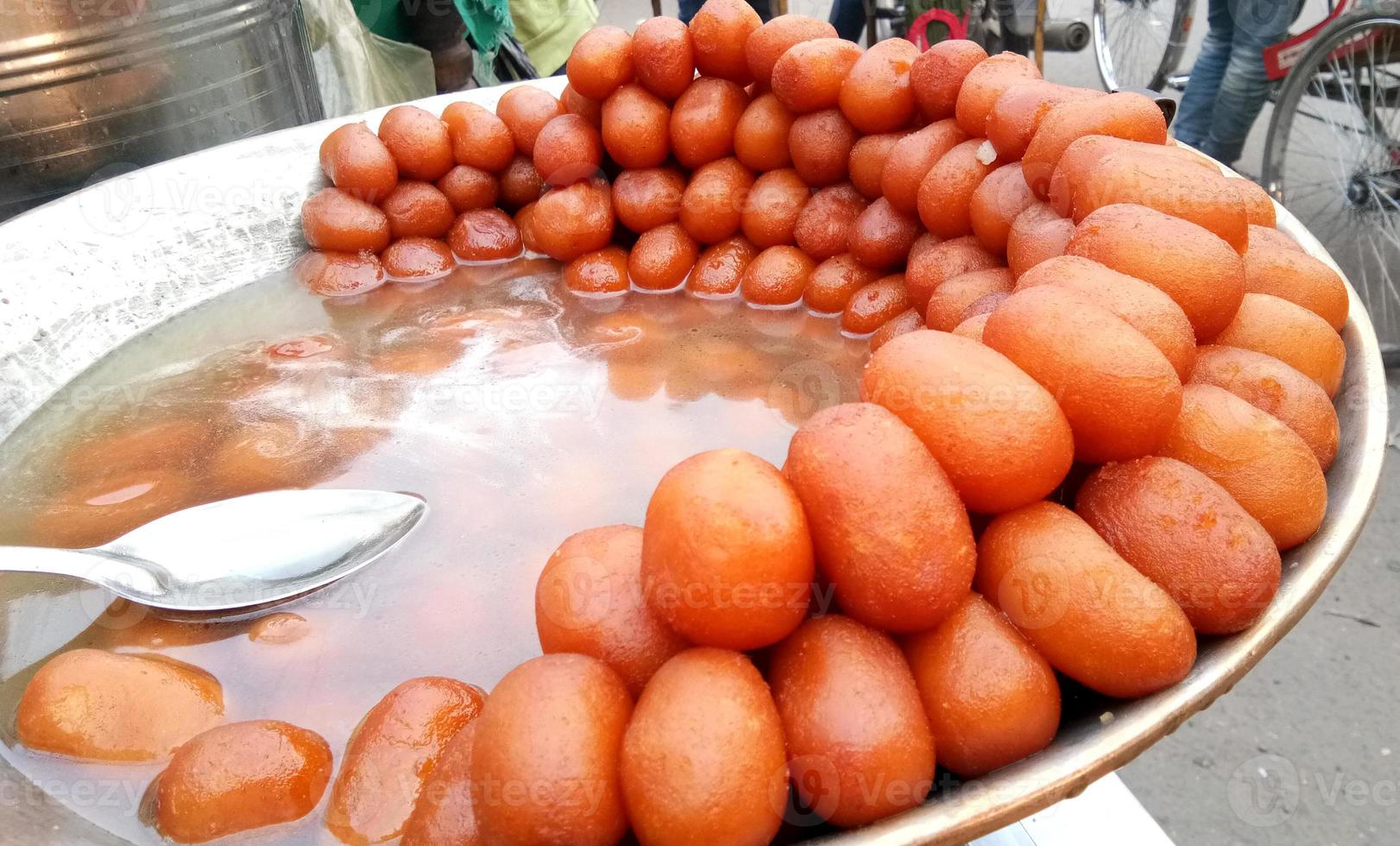 The indian sweet named gulab jamun is selling in local market. photo