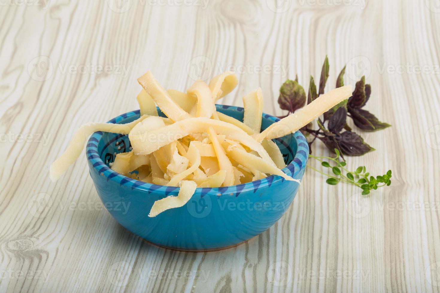 Dried squids in a bowl on wooden background photo
