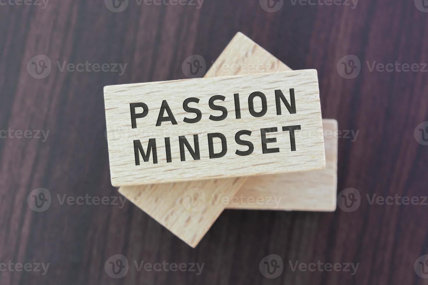 Passion mindset word on wooden block with wooden background. photo